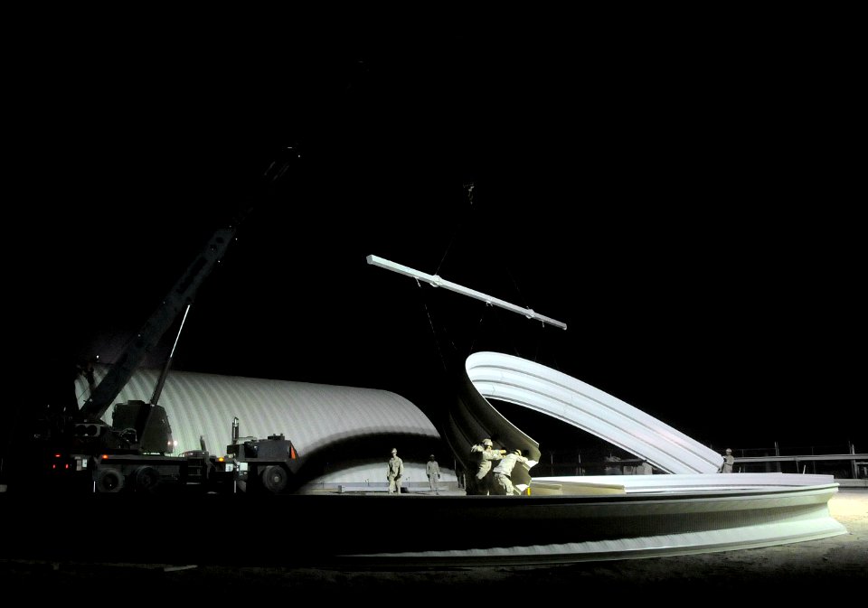 US Navy 100725-N-0475R-235 Seabees assigned to Naval Mobile Construction Battalion (NMCB) 5 erect a K-SPAN building at a project at Camp Leatherneck, Afghanistan