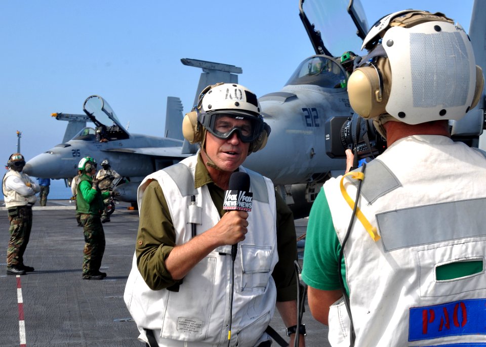 US Navy 100725-N-2013O-143 A civilian journalist records a segment on the flight deck of the aircraft carrier USS George Washington (CVN 73) during flight operations
