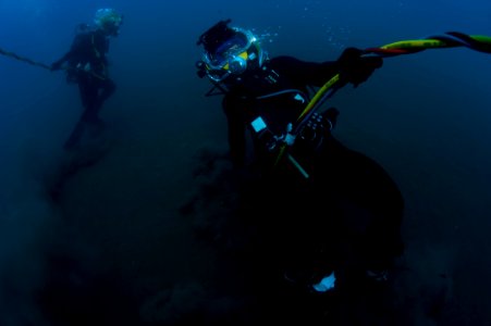 US Navy 100722-N-1134I-298 Navy Diver 2nd Class Troy Crowder and a Mexican navy diver take strain on their dive umbilicals during a salvage recovery exercise