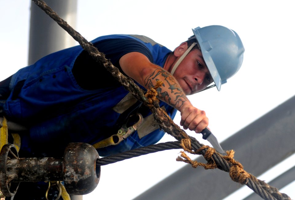 US Navy 100725-N-7280V-262 Seaman Blaine Matteson detaches the heaving line from the wire high line as the U.S. 7th Fleet command ship USS Blue Ridge (LCC 19)