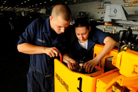US Navy 100726-N-1092P-088 Aviation Ordnanceman David Harris, from Greenville, N.C., and Electrician's Mate Fireman Cheryl Fendlay, from Salem, Va., repair the potentiometer on a forklift