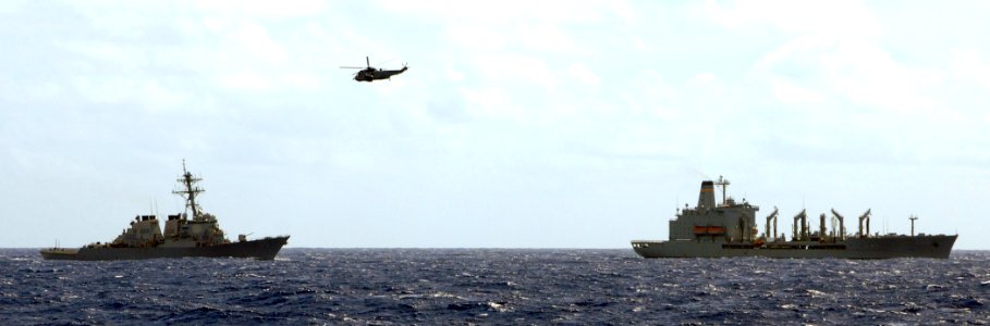 US Navy 100722-N-7058E-072 Canadian navy Sea King helicopter flies over the guided-missile destroyer USS Benfold (DDG 65) and the Military Sealift Command fleet replenishment oiler USNS Guadalupe (T-AO 200)