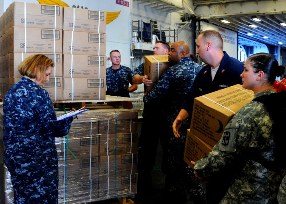 US Navy 100723-N-1531D-109 Sailors aboard USS Iwo Jima (LHD 7) stock MREs (Meals Ready to Eat) during preparation for an upcoming humanitarian assistance mission to Haiti