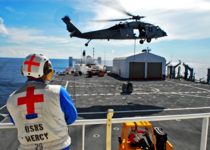 US Navy 100725-N-4044H-209 Hospital Corpsman 3rd Class James Weese observes an MH-60S Sea Hawk helicopter assigned to the Wild Cards of Helicopter Sea Combat Squadron (HSC) 23