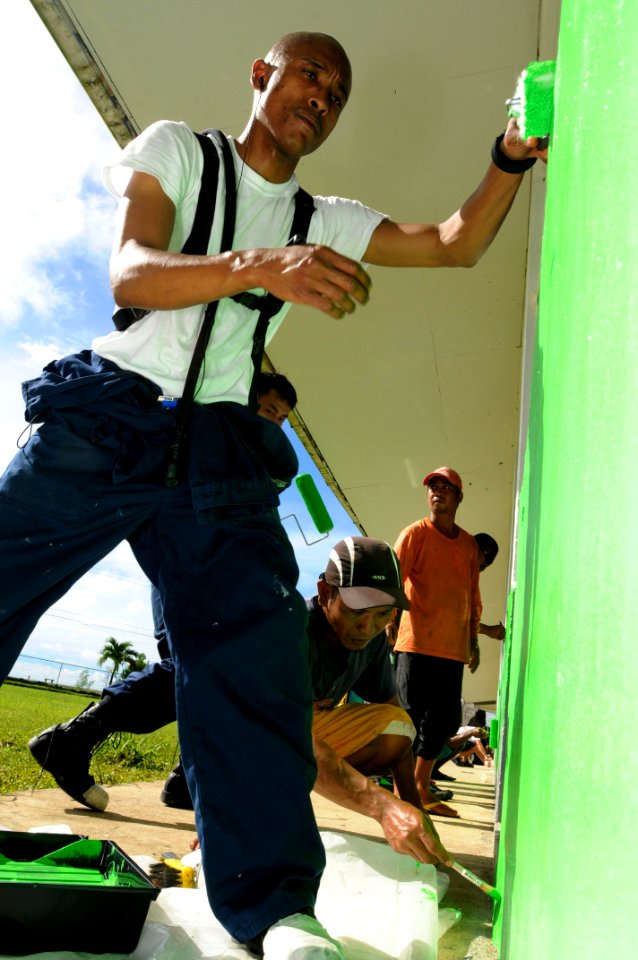 US Navy 100728-N-1675O-517 Operations Specialist 1st Class Angel Aquino helps paint during a Pacific Partnership 2010 community service project at Ngchesar Elementary School