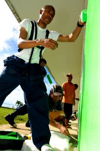 US Navy 100728-N-1675O-517 Operations Specialist 1st Class Angel Aquino helps paint during a Pacific Partnership 2010 community service project at Ngchesar Elementary School