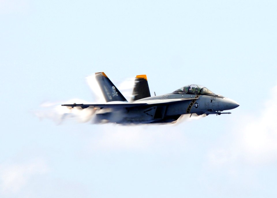 US Navy 100724-N-4236E-764 An F-A-18F Super Hornet assigned to the Jolly Rogers of Strike Fighter Squadron (VFA) 103 flies by the aircraft carrier USS Dwight D. Eisenhower (CVN 69)