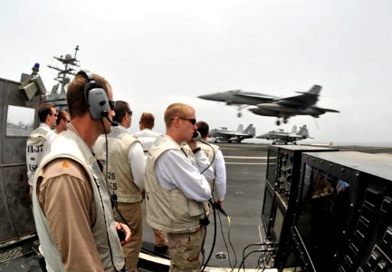 US Navy 100725-N-6003P-244 anding signal officers watch an F-A-18E Super Hornet assigned to the Gunslingers of Strike Fighter Squadron (VFA) 105) land aboard the aircraft carrier USS Harry S. Truman (CVN 75)