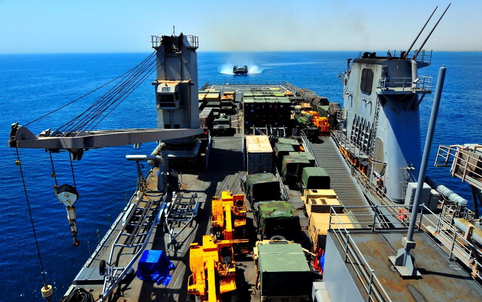 US Navy 100725-N-7948R-433 A landing craft air cushion (LCAC) approaches the stern of the amphibious dock landing ship USS Pearl Harbor (LSD 52)