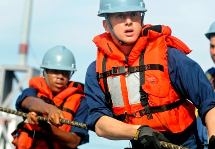 US Navy 100725-N-7280V-263 Seaman James Felsing heaves around the line as the U.S. 7th Fleet command ship USS Blue Ridge (LCC 19)