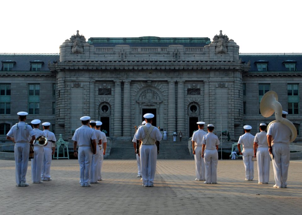 US Navy 100729-N-3857R-004 The U.S. Naval Academy Band stands in formation in front of historic Bancroft Hall before performing morning colors