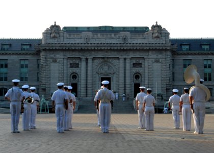 US Navy 100729-N-3857R-004 The U.S. Naval Academy Band stands in formation in front of historic Bancroft Hall before performing morning colors photo