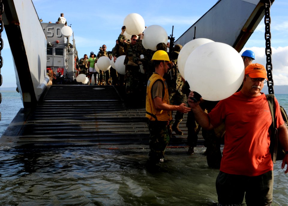US Navy 100729-N-4153W-102 Seabees, Marines and civilians from non-government organizations, debark a landing craft utility (LCU) assigned to the multi-purpose amphibious assault ship USS Iwo Jima (LHD 7),