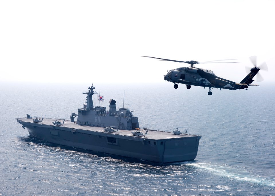 US Navy 100727-N-2013O-128 An SH-60F Sea Hawk helicopter flies by Dokdo (LPH 6111)