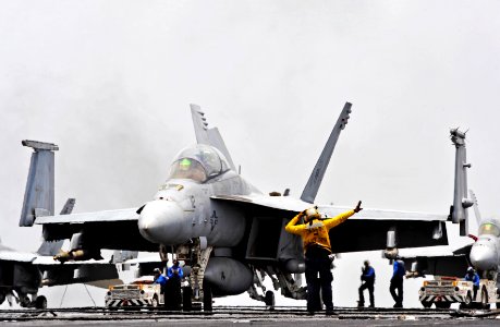 US Navy 100726-N-6003P-127 A plane director signals an F-A-18F Super Hornet, assigned to the Swordsmen of Strike Fighter Squadron (VFA) 32 to the catapult