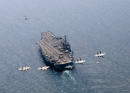 US Navy 100727-N-2013O-075 A U.S. Air Force F-16C Fighting Falcon leads a formation of F-15 Eagles and F-22 Raptors as they fly in formation over USS George Washington (CVN 73)