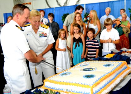 US Navy 100729-N-7908T-141 Rear Adm. Nora W. Tyson, commander of Carrier Strike Group (CSG) 2, cuts a cake with Capt. Jeffrey A. Hesterman after assuming command of the strike group photo