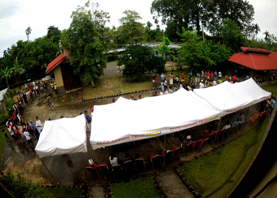 US Navy 100729-N-4031K-204 Paluan residents wait in line at the Ngarachemayong Community Center for a Pacific Partnership medical and dental clinic event held by Sailors from the U.S. 7th Fleet command ship USS Blue Ridge (LCC