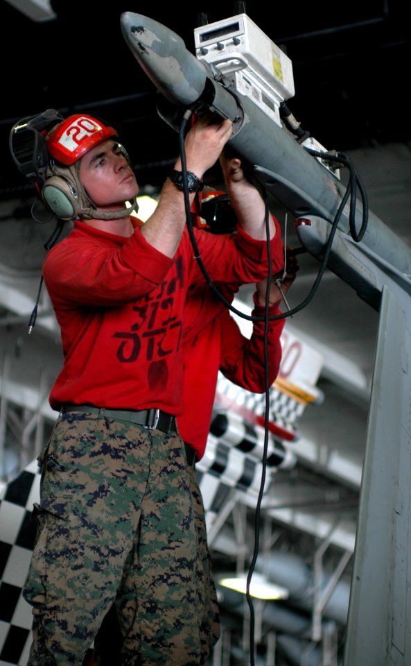 US Navy 100730-N-6427M-120 Cpl. John Alday, assigned to the Checkerboards of Marine Fighter Attack Squadron (VMFA) 312, performs routine trouble shooting during a weapons release and control check on an F-A-18C Hornet