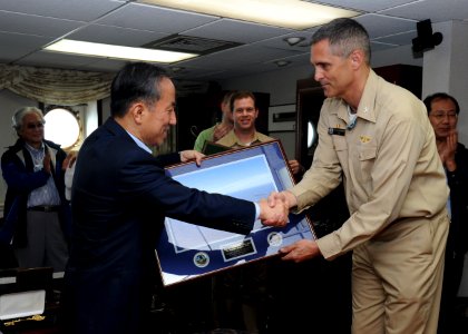 US Navy 100727-N-7191M-079 Capt. David A. Lausman, commanding officer of the aircraft carrier USS George Washington (CVN 73),presents a framed photo to Republic of Korea Minister of National Defense Tae Young Kim