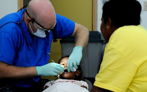 US Navy 100728-N-7280V-363 Lt. Shawn Teutsh extracts a patient's tooth at the Southern Community Health Center in the Republic of Palau