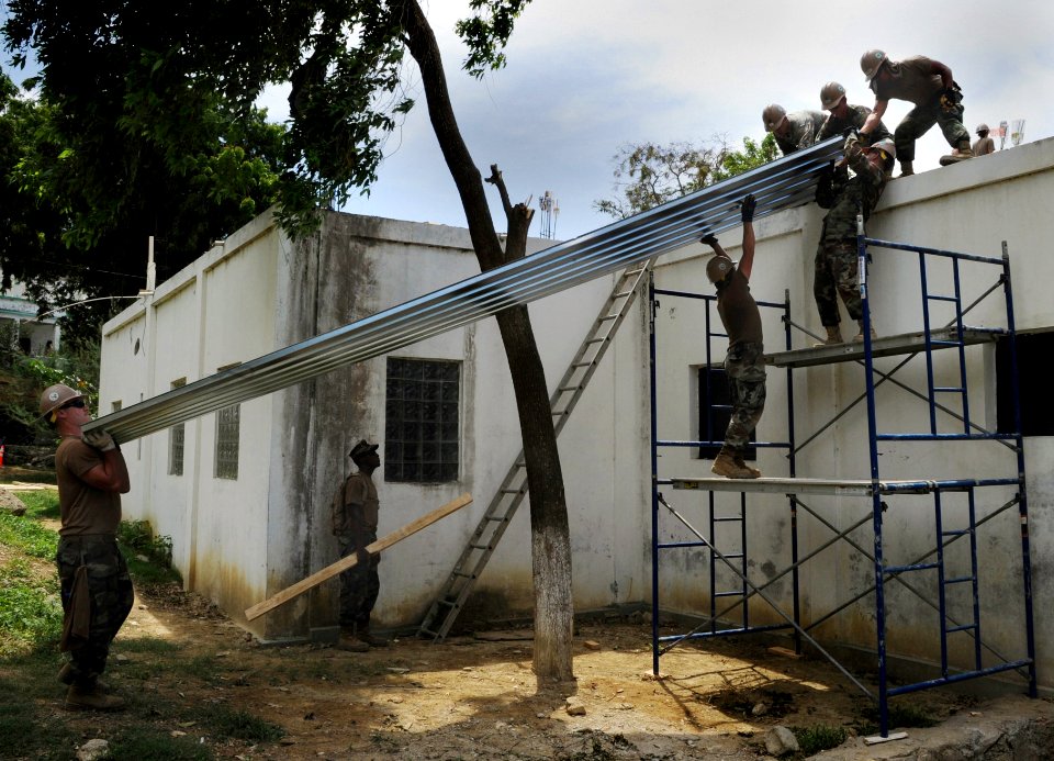 US Navy 100729-N-4153W-381 Seabees assigned to Construction Battalion Mobile Unit (CBMU) 202 and Naval Mobile Construction Battalion (NMCB) 7 build a new roof on a hospital in Port-de-Paix, Haiti