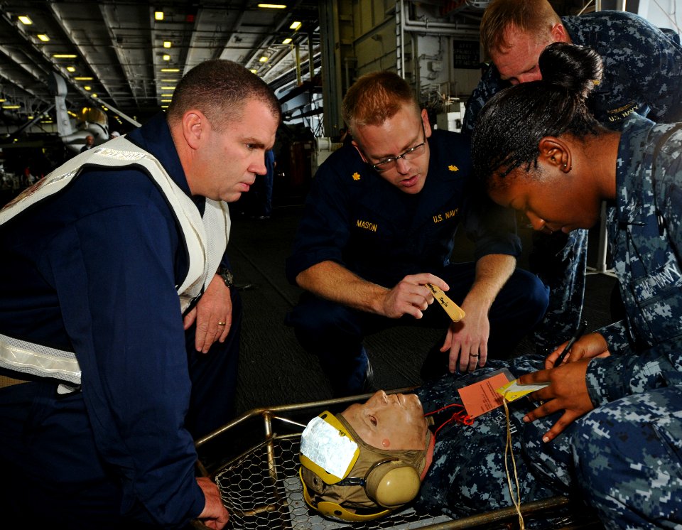 US Navy 100801-N-1092P-023 Medical personnel diagnose the severity of a Sailor's injuries during a mass casualty training drill aboard USS Harry S. Truman (CVN 75)
