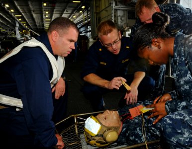 US Navy 100801-N-1092P-023 Medical personnel diagnose the severity of a Sailor's injuries during a mass casualty training drill aboard USS Harry S. Truman (CVN 75)