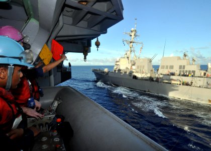 US Navy 100802-N-2013O-034 Sailors aboard the aircraft carrier USS George Washington (CVN 73) participate in a replenishment at sea with the Arleigh Burke-class guided-missile destroyer USS Chung-Hoon (DDG 93)