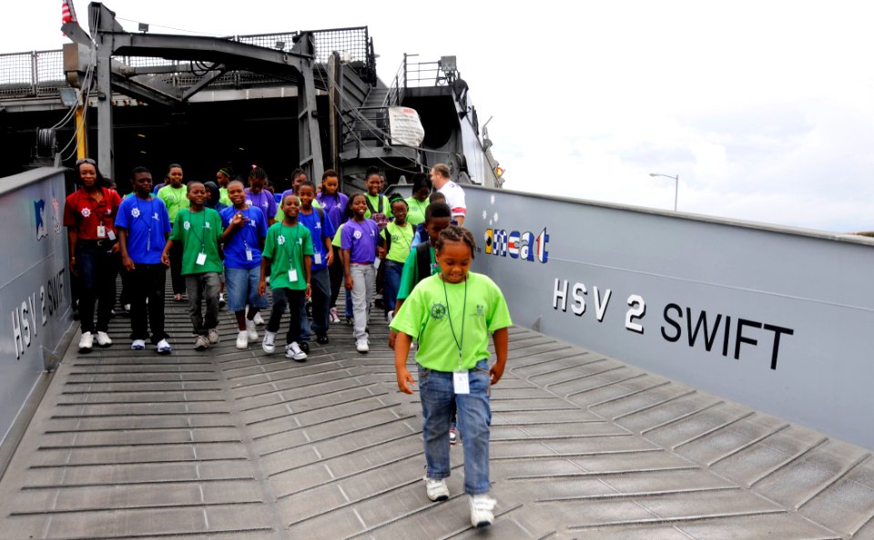 US Navy 100729-N-9643W-514 Day campers from Barbados Port, Inc. Summer Camp 2010 exit High Speed Vessel Swift (HSV 2) after touring the vessel. Swift is deployed supporting Southern Partnership Station 2010 photo