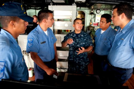 US Navy 100802-N-5319A-046 Culinary Specialist 2nd Class Edwin Mayorga gives a tour of the amphibious transport dock ship USS New Orleans (LPD 18) to Colombian navy sailors during a port visit to Bahia Malaga Naval Base