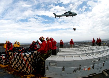 US Navy 100730-N-4830B-012 ailors aboard the aircraft carrier USS George Washington (CVN 73) handle cargo during a replenishment at sea with the Military Sealift Command fleet replenishment oiler USNS Walter S. Diehl (T-AO 193)