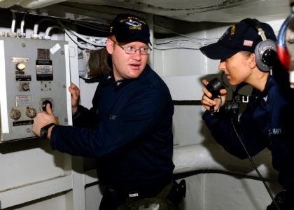 US Navy 100730-N-0569K-020 Machinist's Mate 3rd Class Daniel C. Hansen, left, and Electrician's Mate 3rd Class Chelsea D. Waters to power the pumps that align the aqueous film forming foam photo