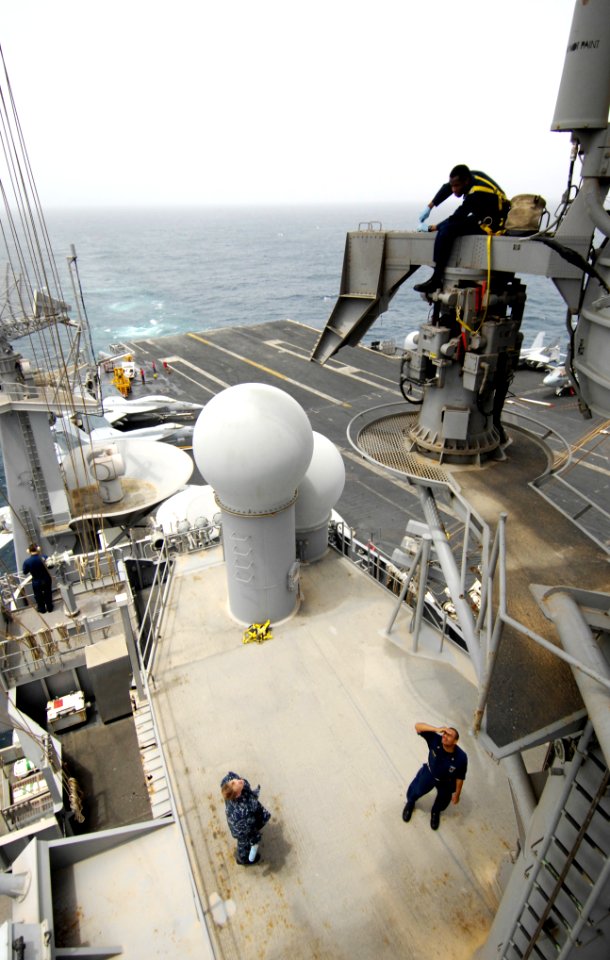 US Navy 100730-N-6362C-029 Electronics Technician 3rd Class Jason Patterson performs monthly maintenance on the AN-SPN-43 primary aircraft control radar on the mast of the aircraft carrier USS Harry S. Truman (CVN 75)