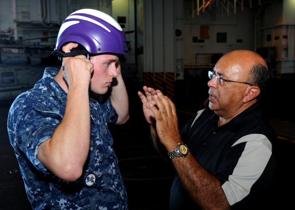 US Navy 100803-N-5838W-049 Aviation Boatswain's Mate (Fuel) Airman William P. Hanahan tests a new prototype cranial for Jim Rodriguez