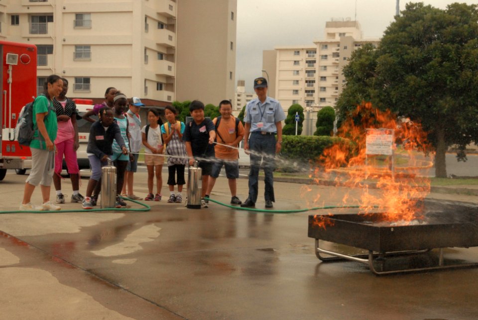 US Navy 100730-N-2218S-086 Children from Commander, Fleet Activities Yokosuka and the city of Yokosuka use fire extinguishers to put out a fire at the 15th annual U.S. and Japan Fire Prevention Camp Adventure