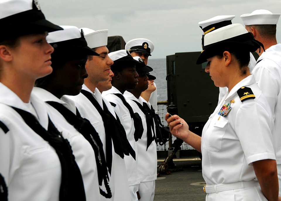 US Navy 100804-N-1082Z-030 Lt. j.g. Karla V. Fuentes checks an ID card as she conducts a uniform inspection on Sailors aboard USS Ashland (LSD 48)