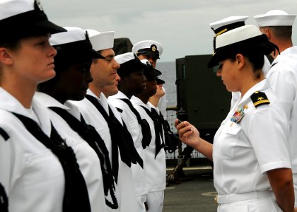 US Navy 100804-N-1082Z-030 Lt. j.g. Karla V. Fuentes checks an ID card as she conducts a uniform inspection on Sailors aboard USS Ashland (LSD 48)