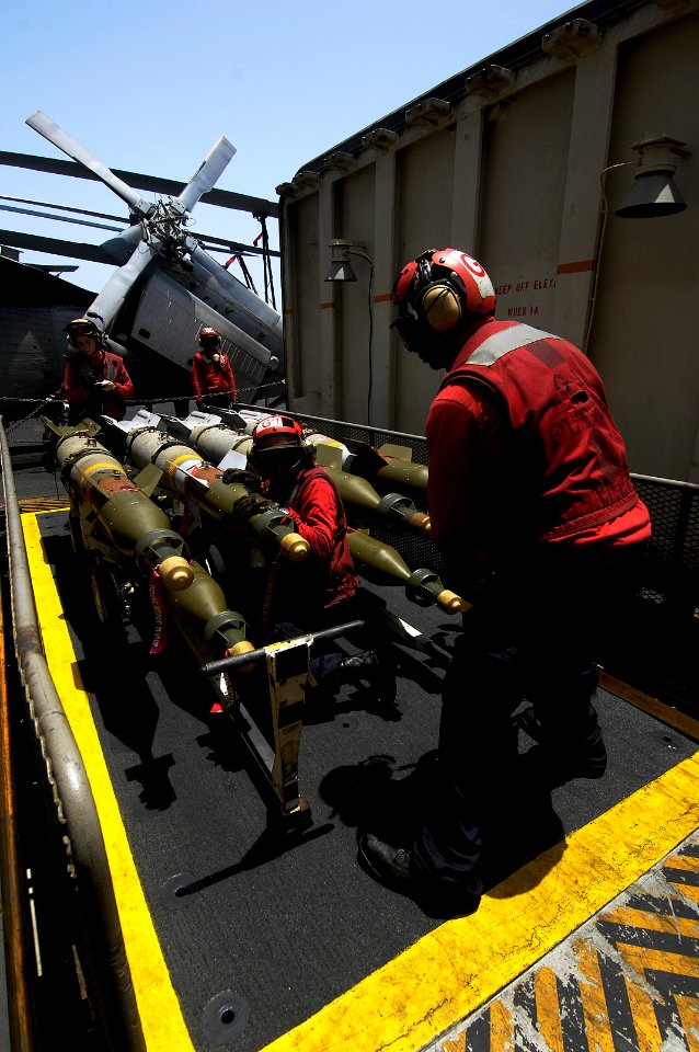 US Navy 100804-N-4135M-097 Aviation Ordnancemen aboard the aircraft carrier USS Harry S. Truman (CVN 75) move bombs from the ordnance elevator onto the flight deck