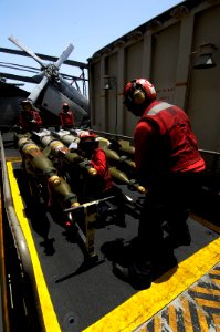 US Navy 100804-N-4135M-097 Aviation Ordnancemen aboard the aircraft carrier USS Harry S. Truman (CVN 75) move bombs from the ordnance elevator onto the flight deck
