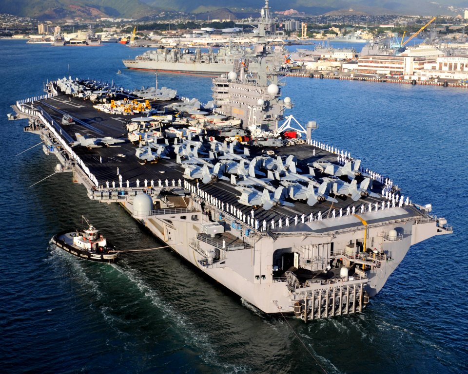 US Navy 100731-N-7605J-676 ailors and Marines man the rails aboard the aircraft carrier USS Ronald Reagan (CVN 76) as the ship arrives in Pearl Harbor for a scheduled port visit