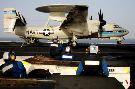 US Navy 100801-N-6362C-244 Sailors watch an E2-C Hawkeye assigned to the Seahawks of Airborne Early Warning Squadron (VAW) 126 land aboard the aircraft carrier USS Harry S. Truman (CVN 75)