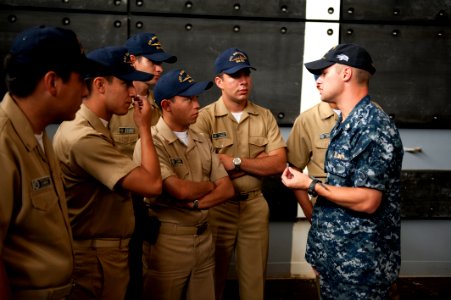 US Navy 100802-N-5319A-024 Ensign Benjamin Hall gives a tour of the amphibious transport dock ship USS New Orleans (LPD 18) to Colombian navy sailors during a port visit to Bahia Malaga Naval Base photo