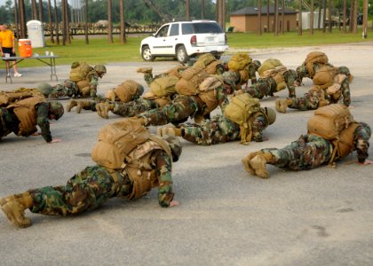 US Navy 100806-N-9564W-123 Seabees perform push-ups in gear during a battalion Readiness Exercise held on Naval Construction Battalion Center, Gulfport