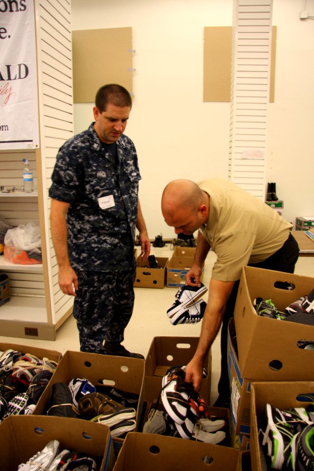 US Navy 100806-N-6936D-020 Sailors sort shoes that will be given to children in need through the Klothes for Kids program