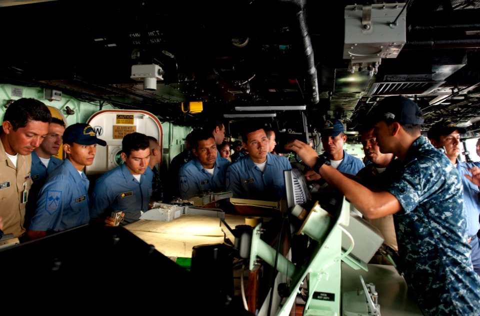 US Navy 100802-N-5319A-036 Quarter Master 3rd Class Daniel Urbano gives a tour of the amphibious transport dock ship USS New Orleans (LPD 18) to Colombian navy sailors during a port visit to Bahia Malaga Naval Base