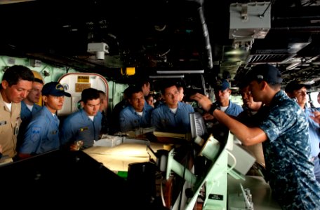 US Navy 100802-N-5319A-036 Quarter Master 3rd Class Daniel Urbano gives a tour of the amphibious transport dock ship USS New Orleans (LPD 18) to Colombian navy sailors during a port visit to Bahia Malaga Naval Base photo