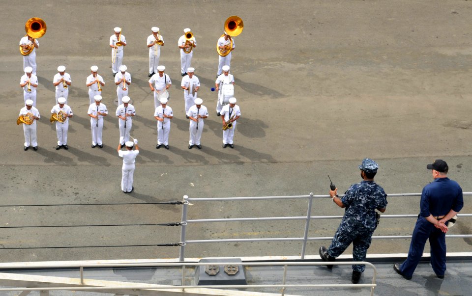 US Navy 100807-N-1675O-157 Culinary Specialist 1st Class Demond Ricard, left, and Command Master Chief Wayne Reu, watch the Philippine navy band perform