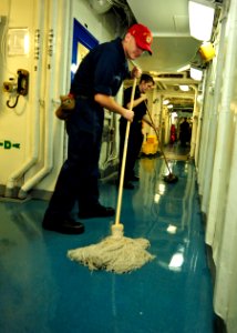 US Navy 100803-N-0569K-029 Electrician's Mate Fireman Apprentice Brian J. Stuart and Electrician's Mate 3rd Class Katrina L. White swab a passageway aboard the aircraft carrier USS Enterprise (CVN 65)