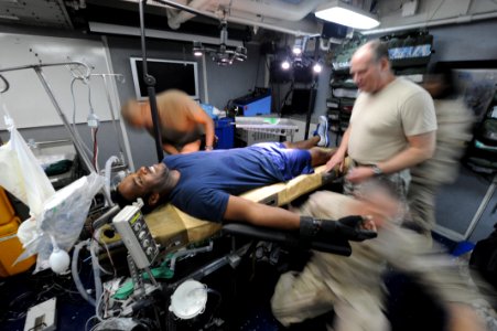 US Navy 100803-N-6463B-143 U.S. Coast Guard Maritime Enforcement Specialist 3rd Class Cleven Brown acts as a trauma patient as Sailors assigned to Expeditionary Resuscitative Surgical Support Team 1
